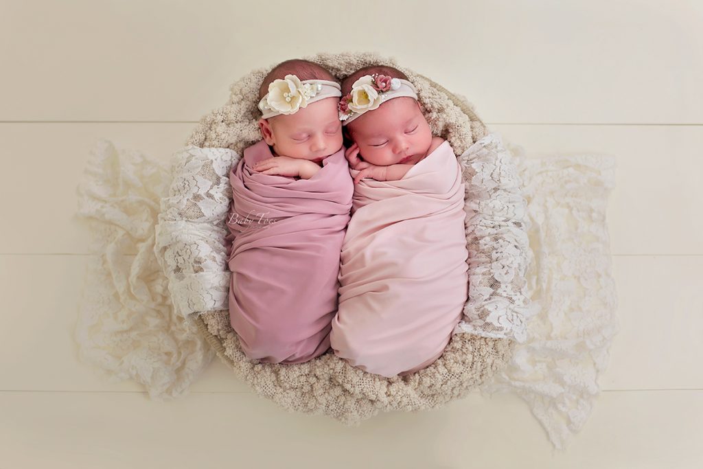 newborn twins in a bowl