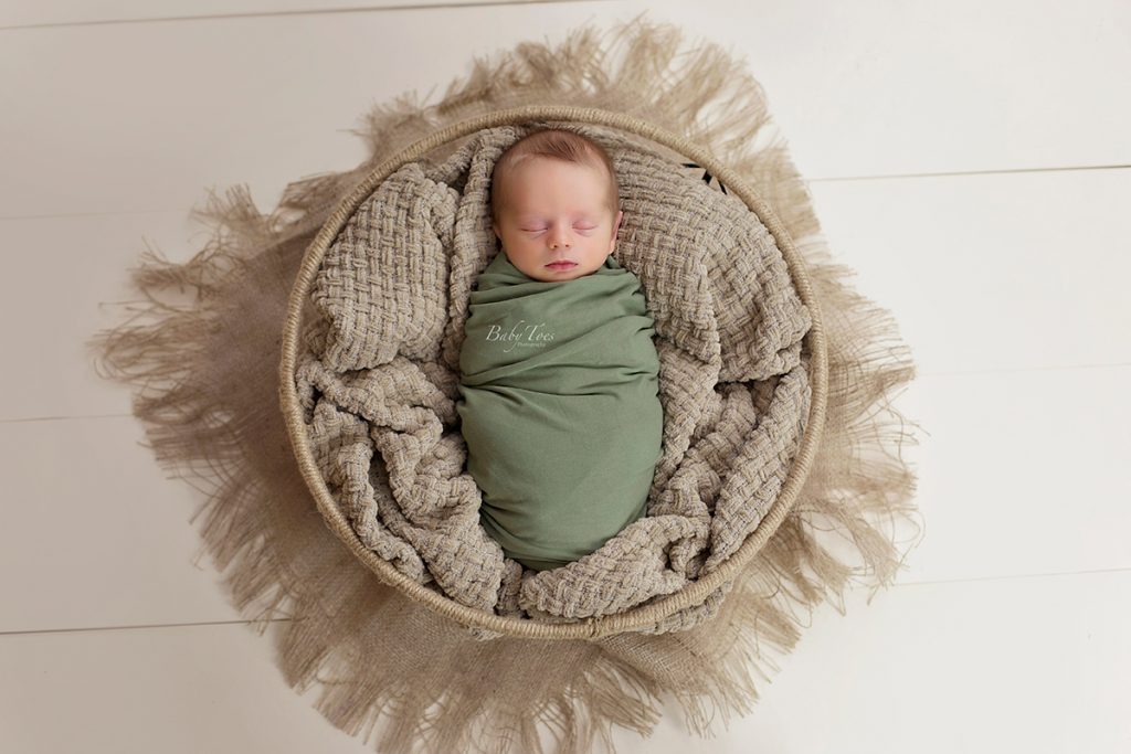 newborn boy in basket