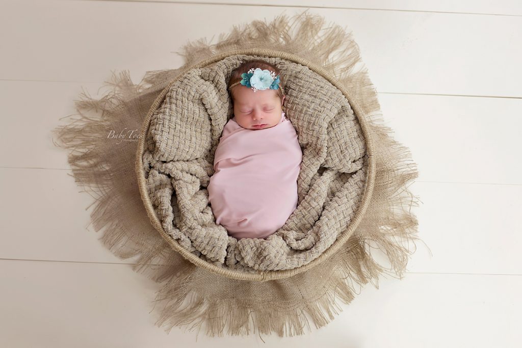 newborn girl in basket
